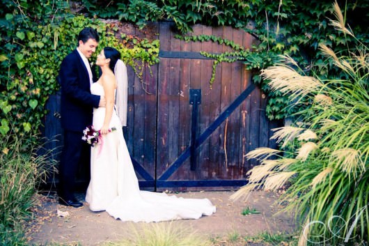 bride and groom in gardens by wine cave at hans fahden winery in calistoga- wine country wedding portraits
