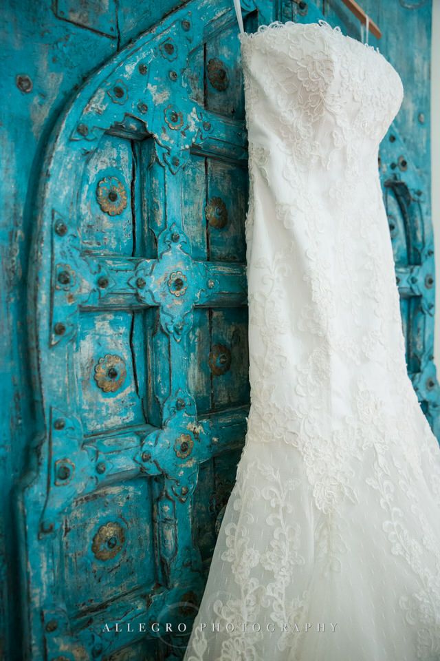 wedding dress and turquoise door - photo by Allegro Photography