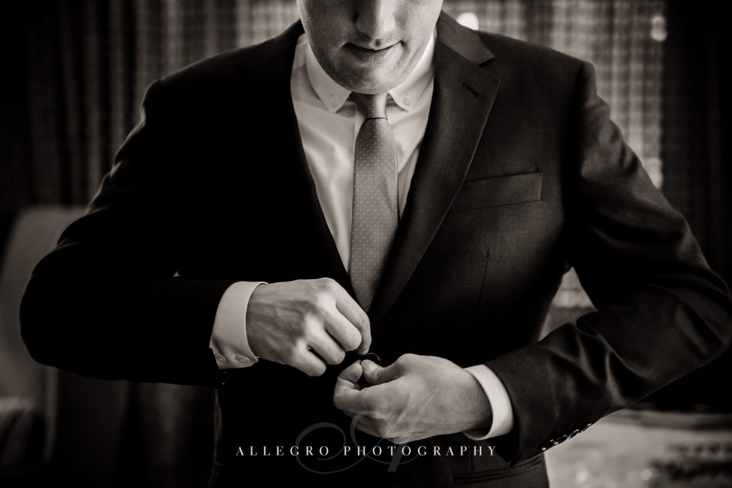 groom buttons up wedding prep -photo by allegro photography