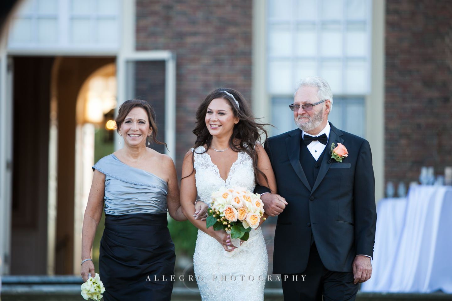 bride with her parents walking down the aisle- - photo by Allegro Photography