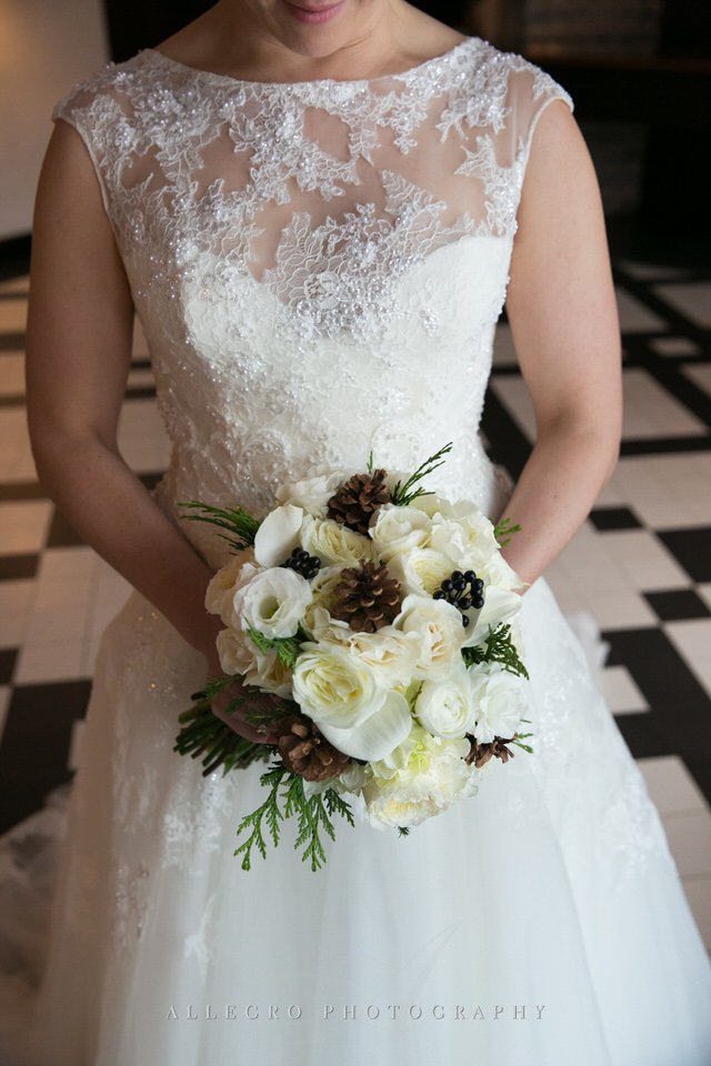 brides bouquet with white roses pinecones