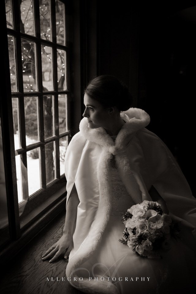 fur lined wrap for bride at window- winter wedding willowdale topsfield ma