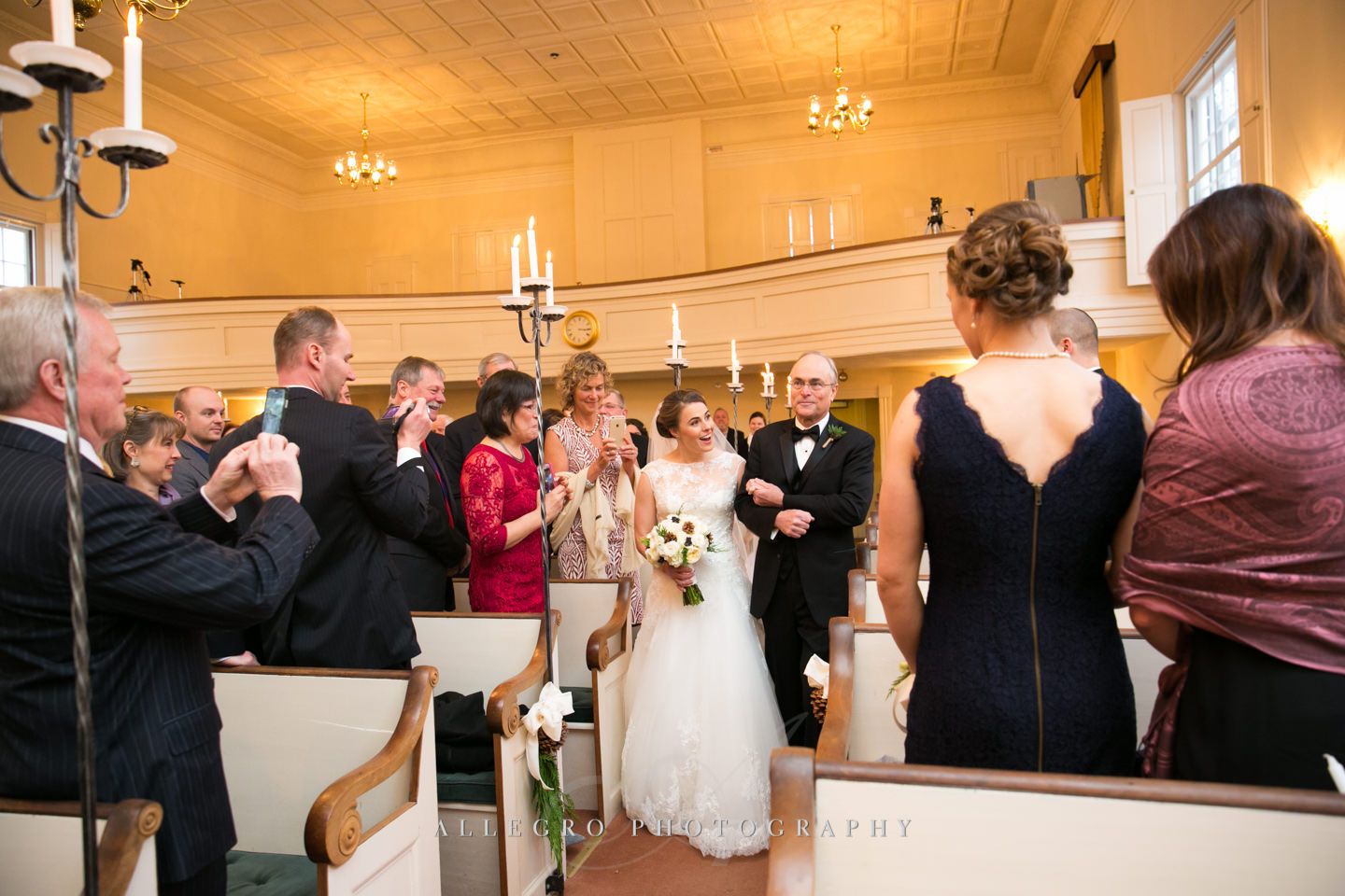 bride walks down aisle during wedding ceremony