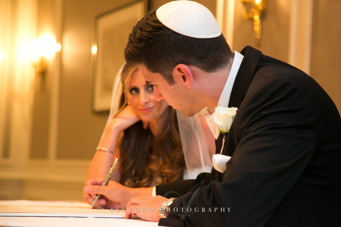 signing the ketubah - copley plaza boston- photo by allegro photography