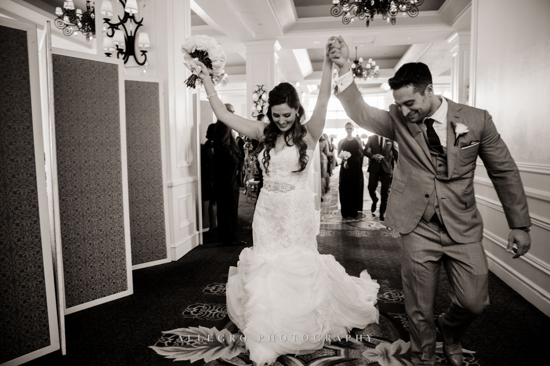 bride and groom celebrating at the boston harbor hotel - photo by allegro photography