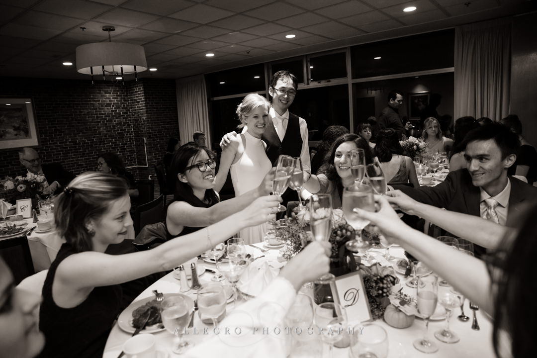 Bride and groom toasting with friends