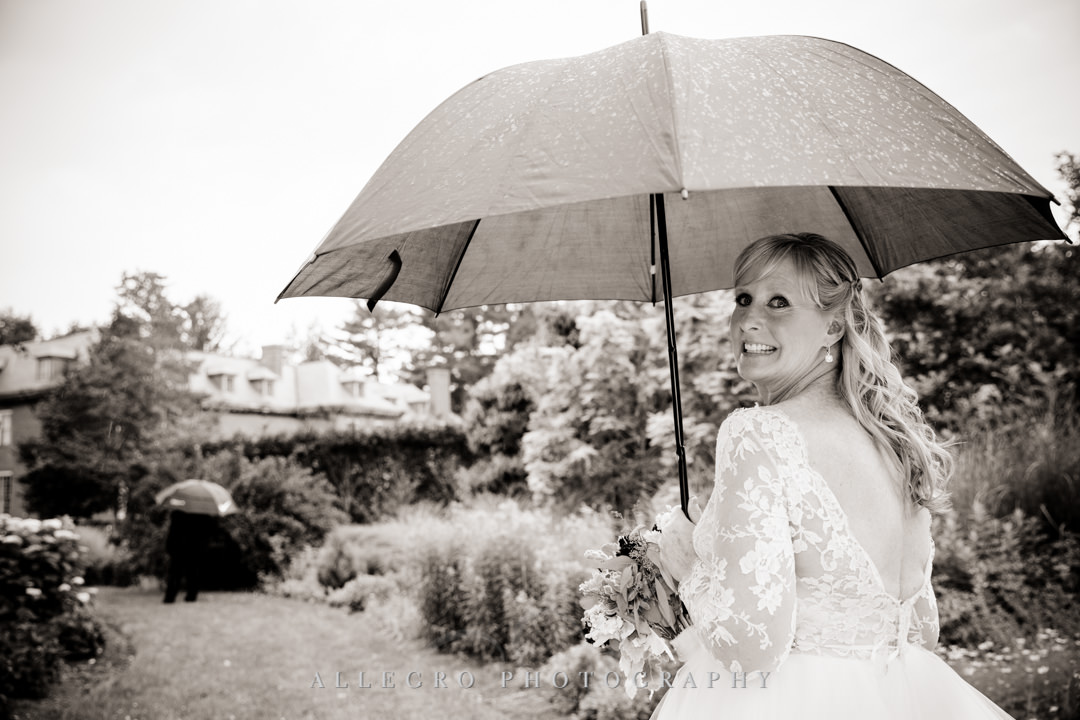 Bride holding an umbrella at Elm Bank Gardens | Allegro Photography