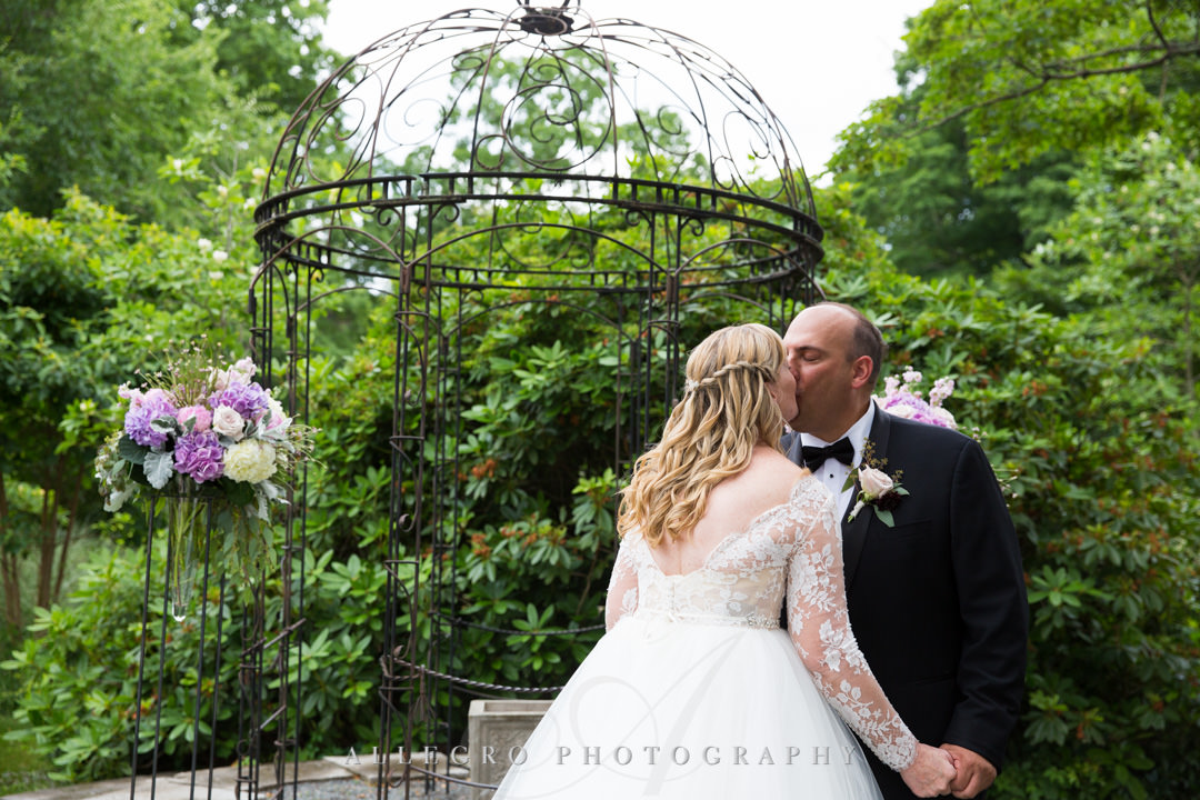 Bridge and groom kiss at Gardens at Elm Bank wedding | Allegro Photography