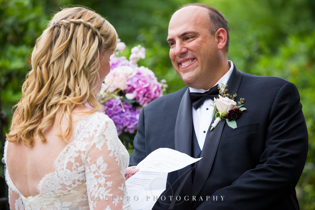 Groom smiles as his bride reads him her vows | Allegro Photography