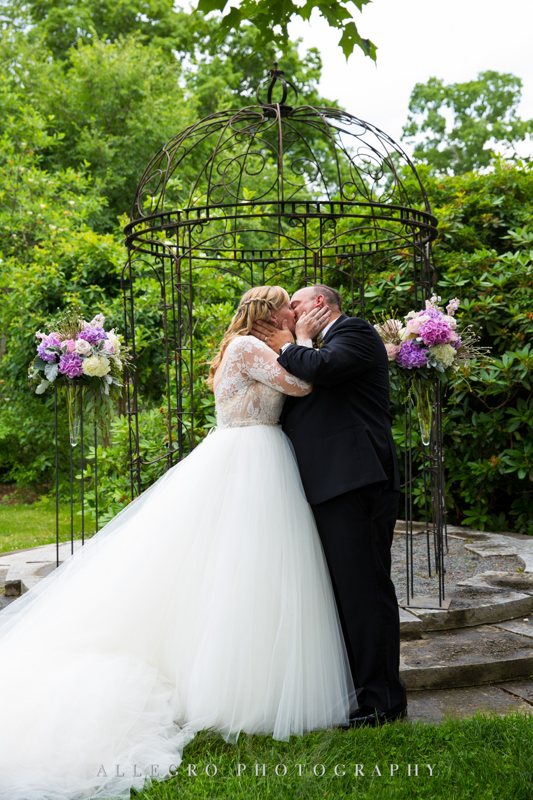 Wedding couple kiss at alter | Allegro Photography