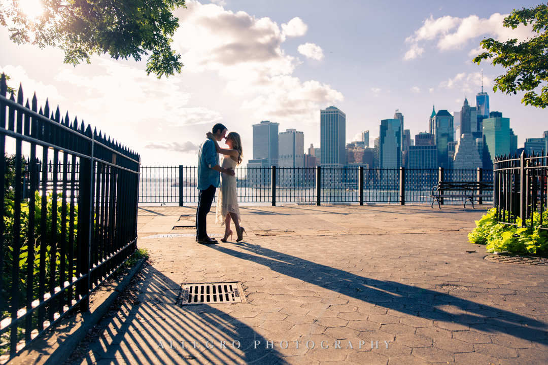 Couple in love standing against NYC skyline | Allegro Photography