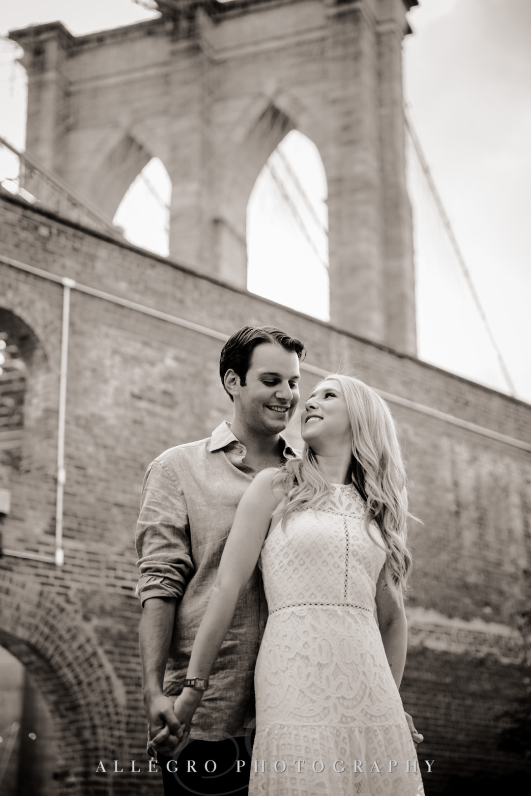 Engaged couple in front of Brooklyn Bridge | Allegro Photography