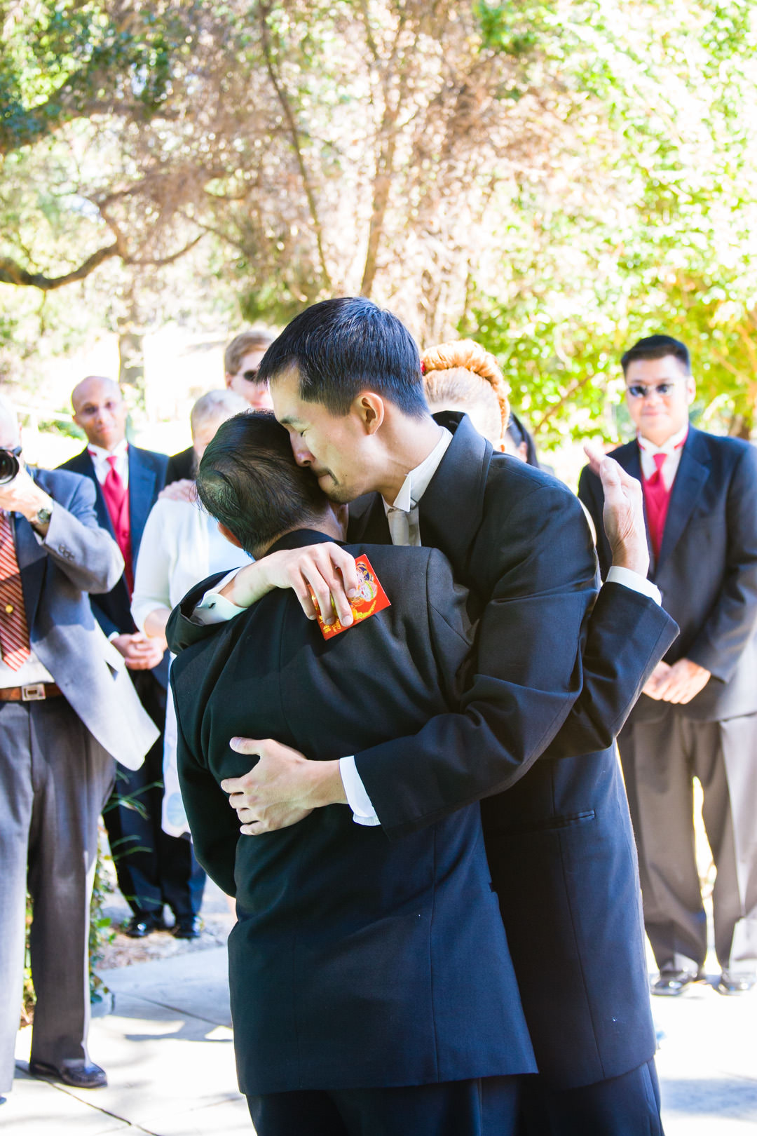 Groom hugs his father before wedding