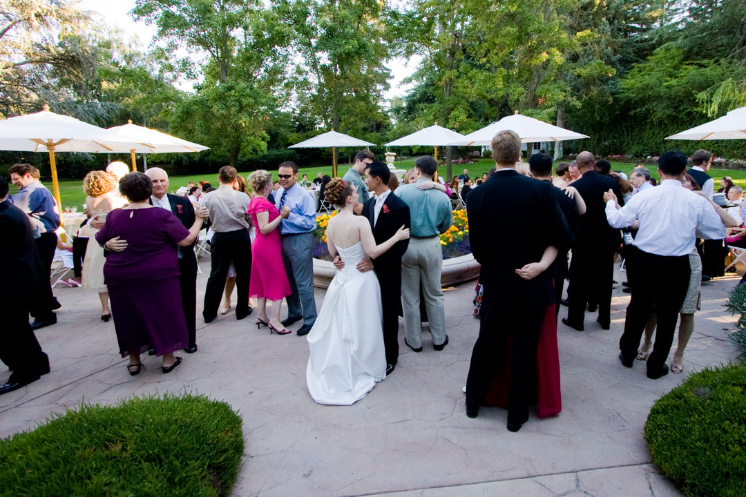 Wedding guests dance outside on dance floor