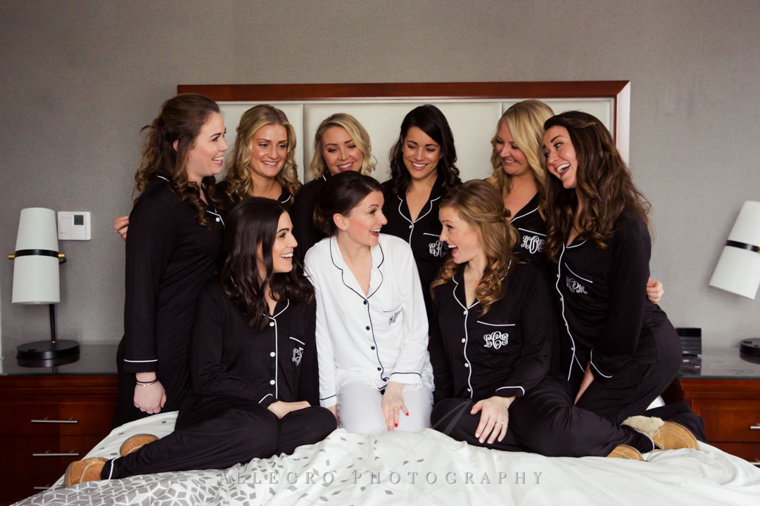 Brides laugh with her bridesmaids
