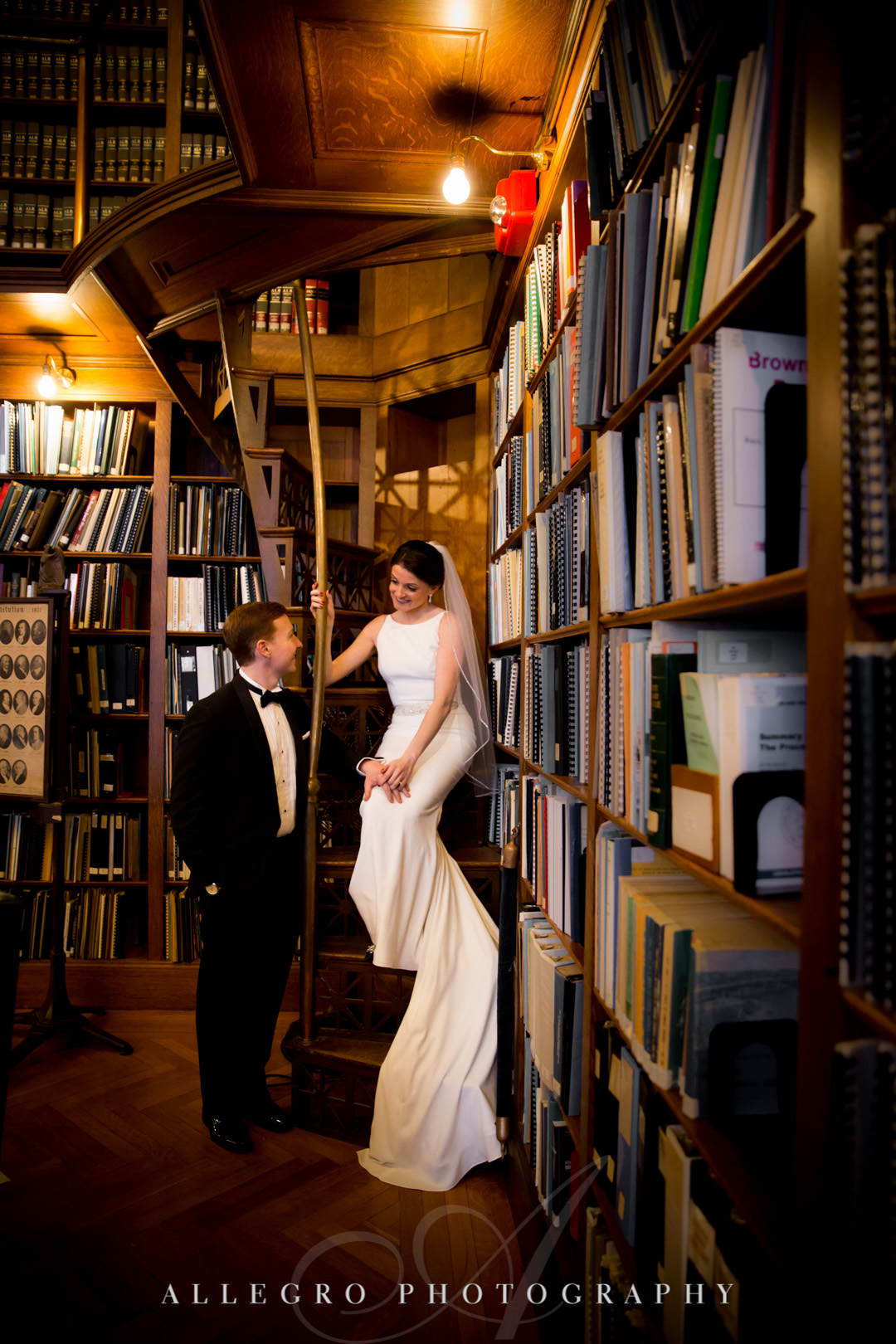Bride and groom pose in library stacks of the rhode island state house, providence