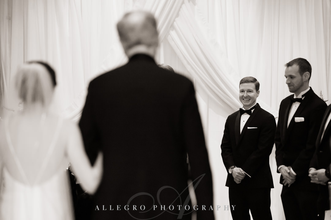 Groom awaits his bride at the alter