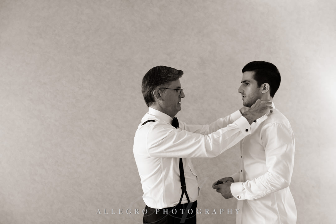 Groom's father helps groom with collar