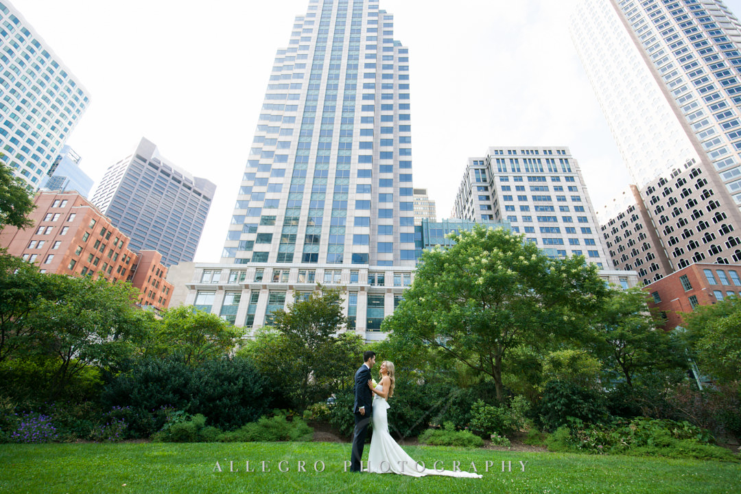 Bride and groom pose in front of state room building in Boston