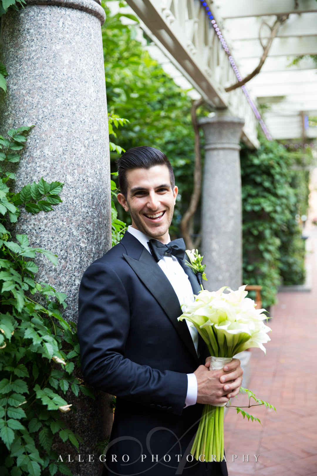 Groom poses with bouquet