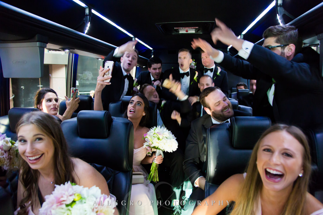 Wedding party dancing in bus on way to wedding