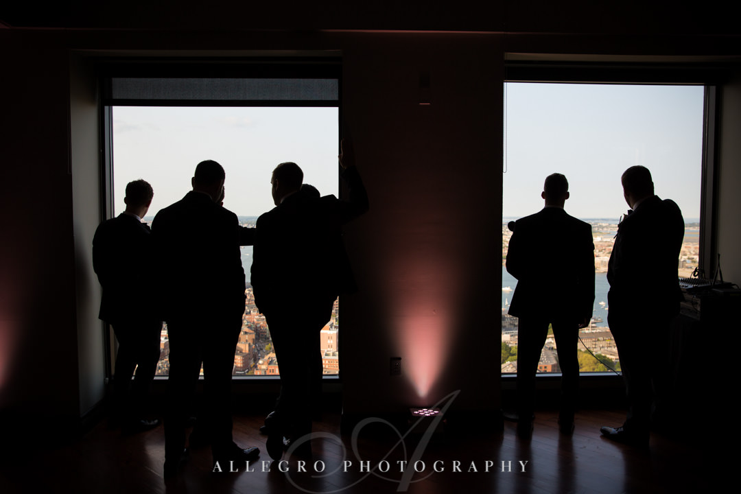 Groomsmen stare out at view of Boston