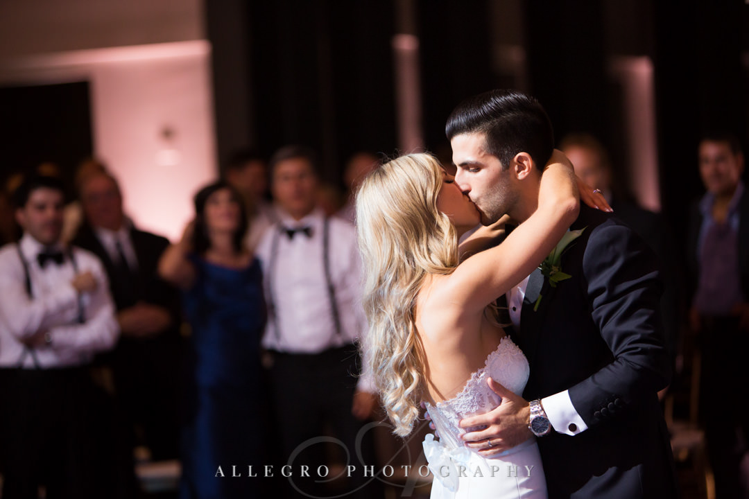 Bride and groom kiss on dance floor