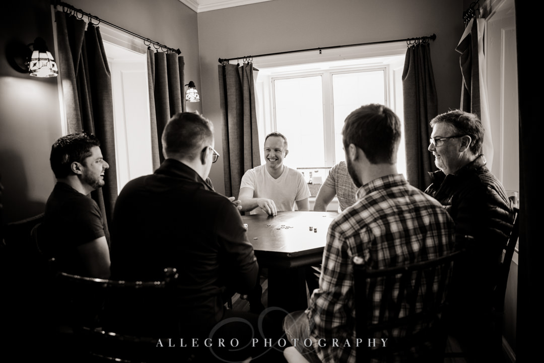 Groomsmen play poker with groom
