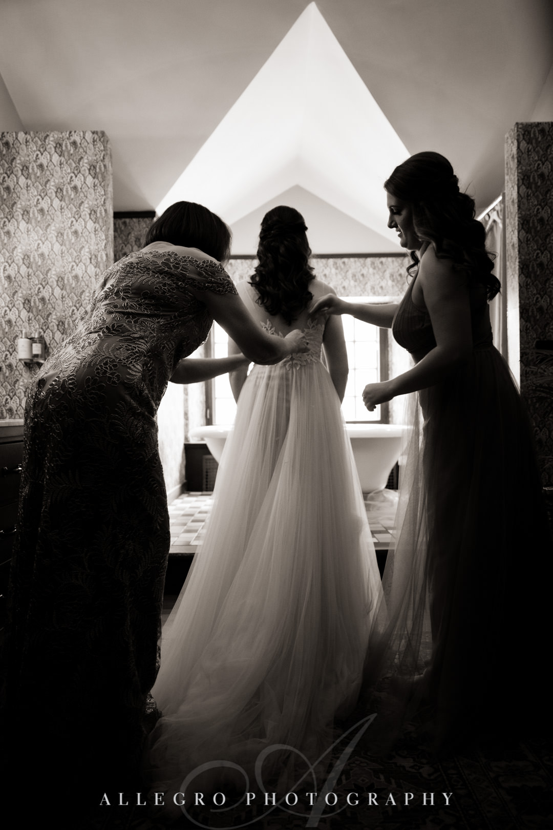 Bridesmaids help bride with her veil