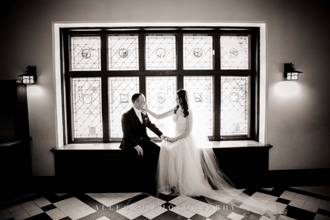 Bride and groom pose for black and white wedding portrait