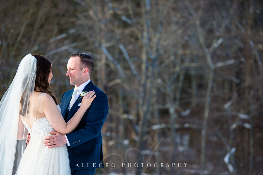 Bride and groom stare lovingly at each other on a winter wedding day