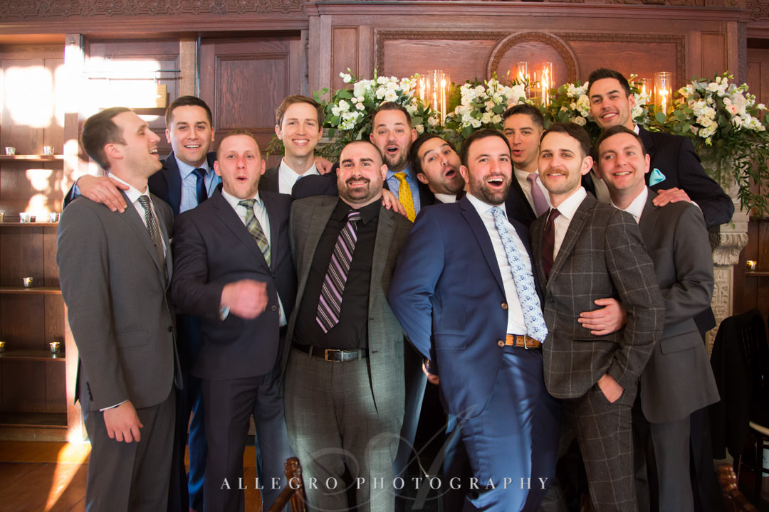 Men attending wedding pose for silly picture