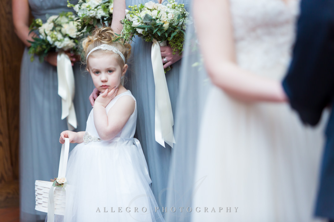 Flower girl watches bride and groom