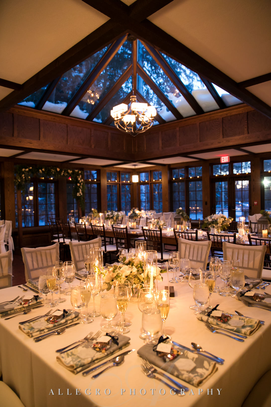 Elegant wedding place settings under evening skylight