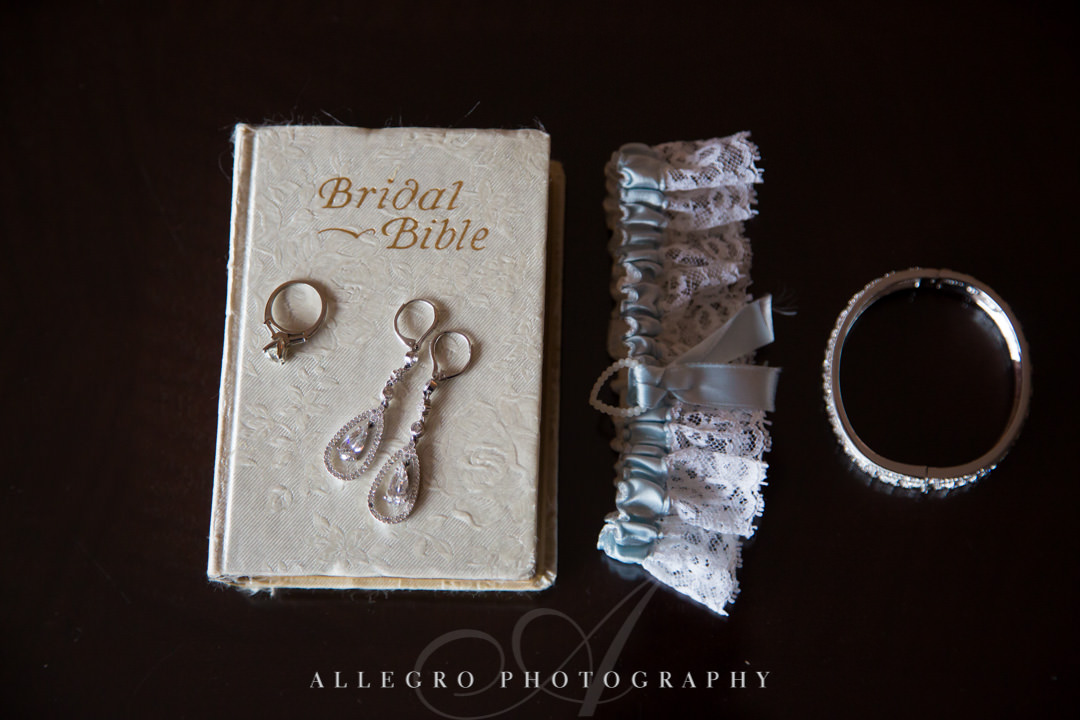 Wedding jewelry atop "Bridal Bible" | Allegro Photography