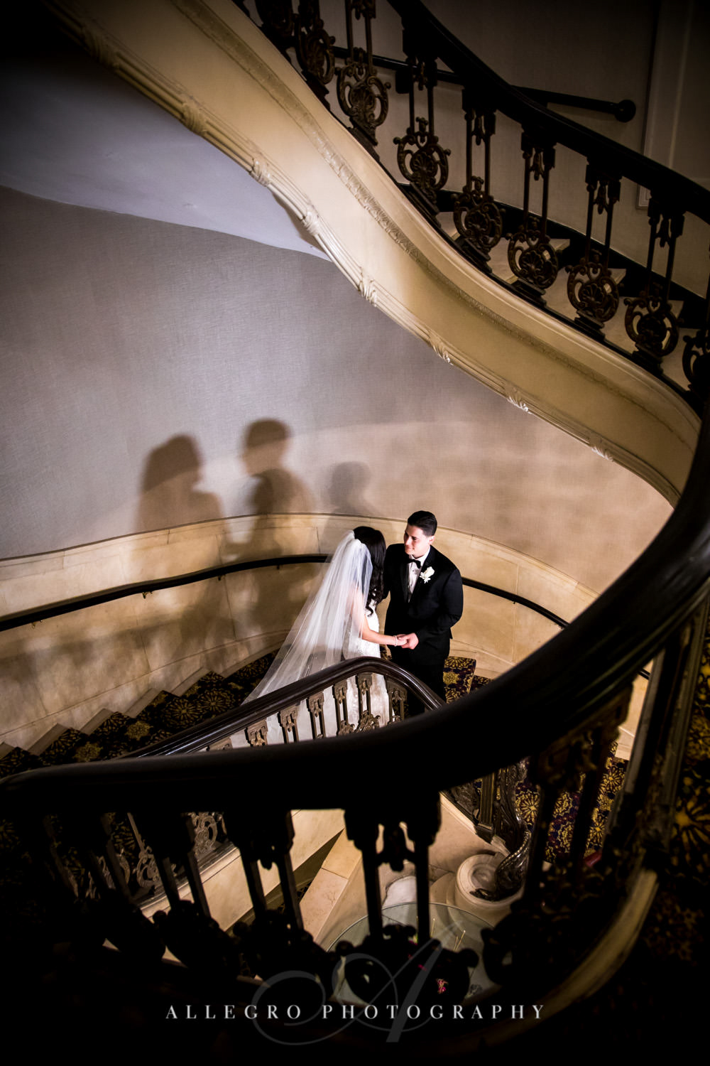 bride and groom hold hands while on the stairs