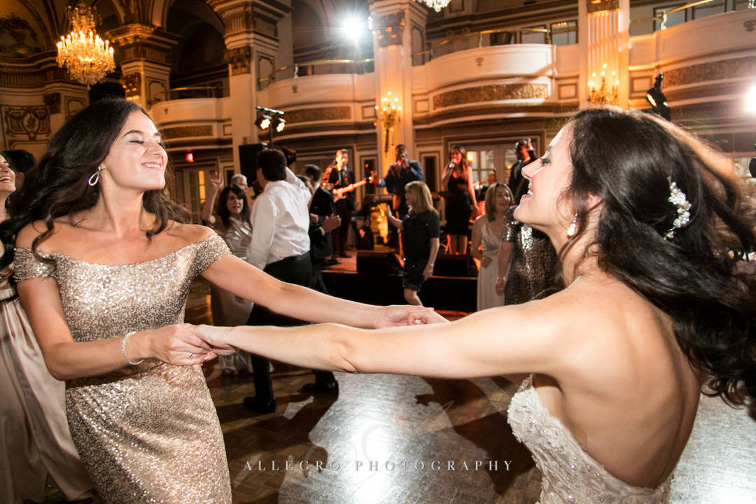 bride and maid of honor dancing together