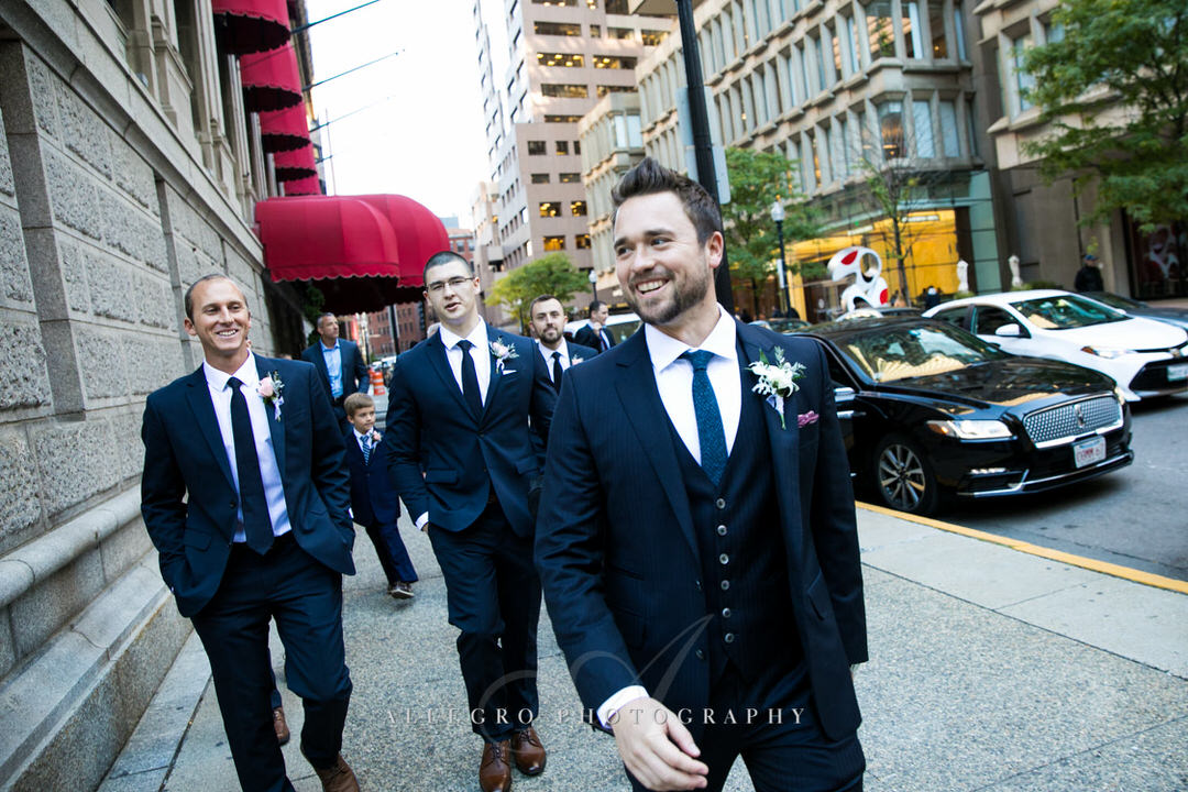 Smiling groom walking with his groomsmen