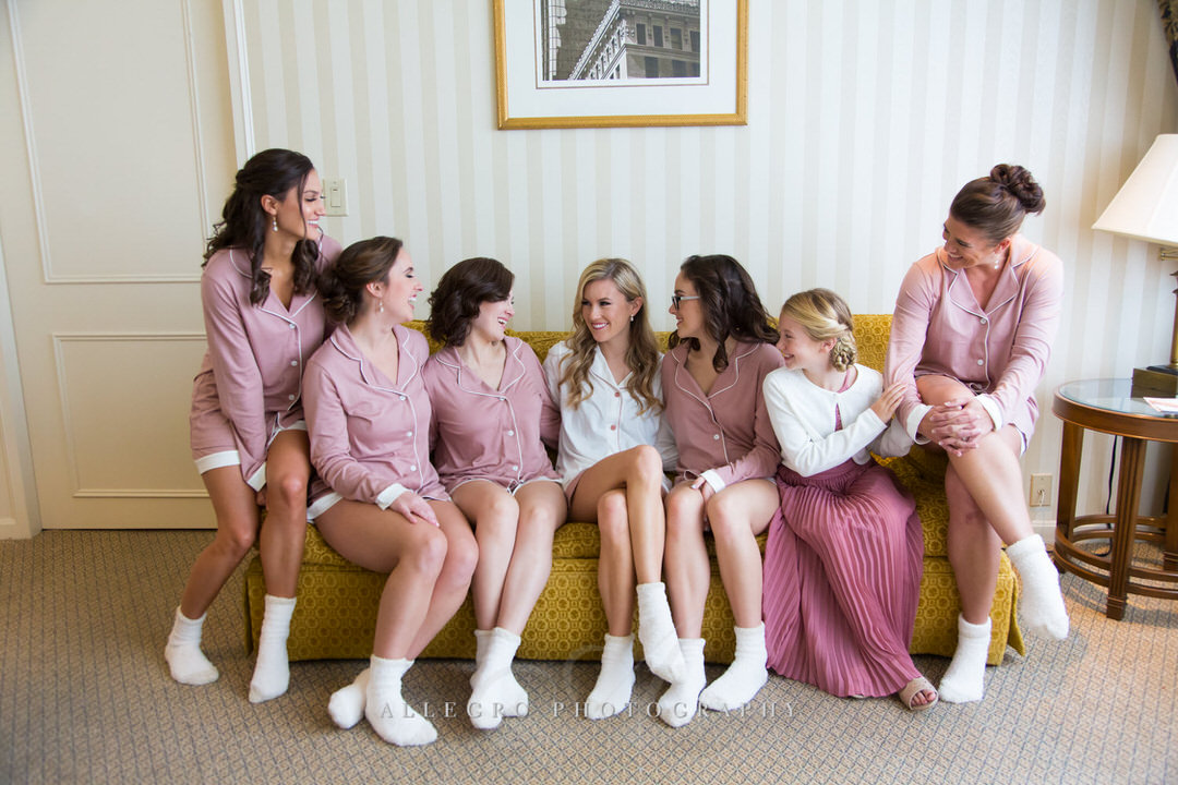 Bride and Bridesmaids share laughs while getting ready