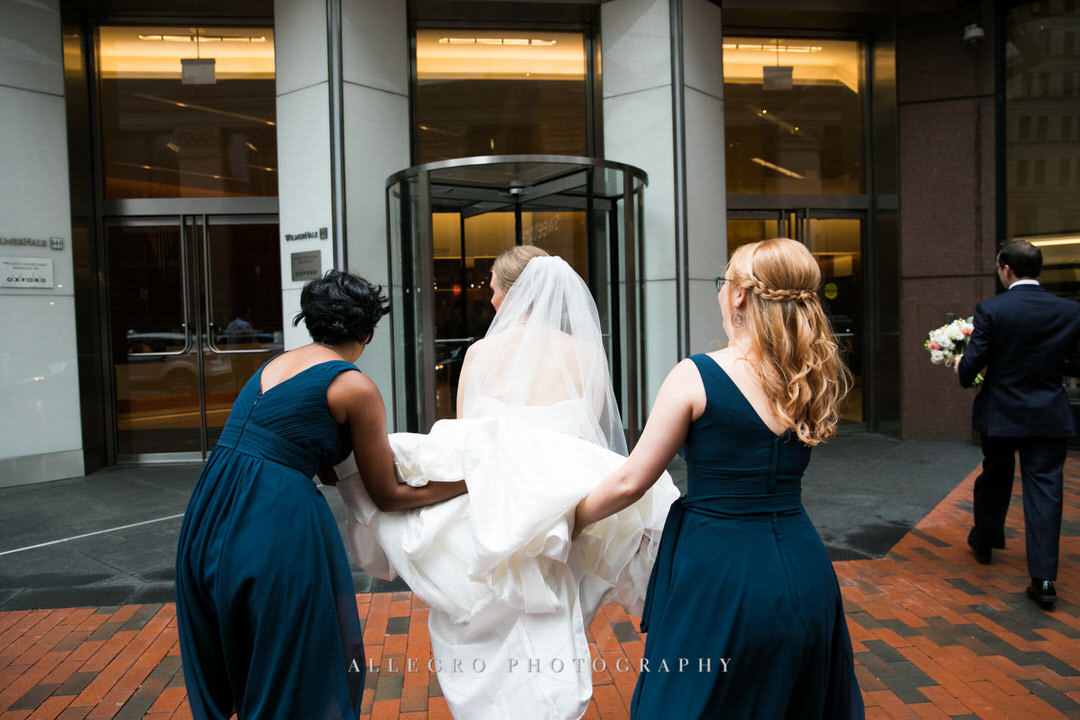 bridesmaids help bride with dress train