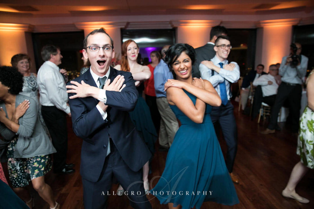 groomsman and bridesmaid have fun dancing