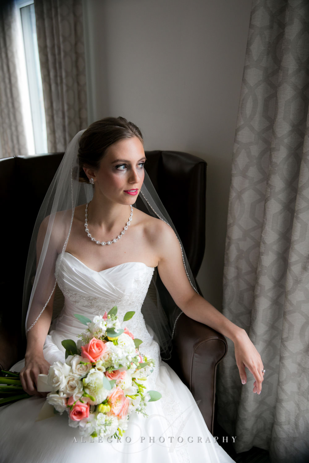 bride looks out window as she is ready