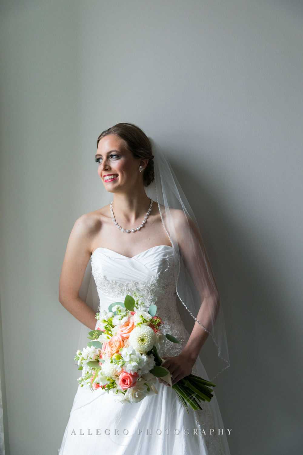 bride smiles with bouquet