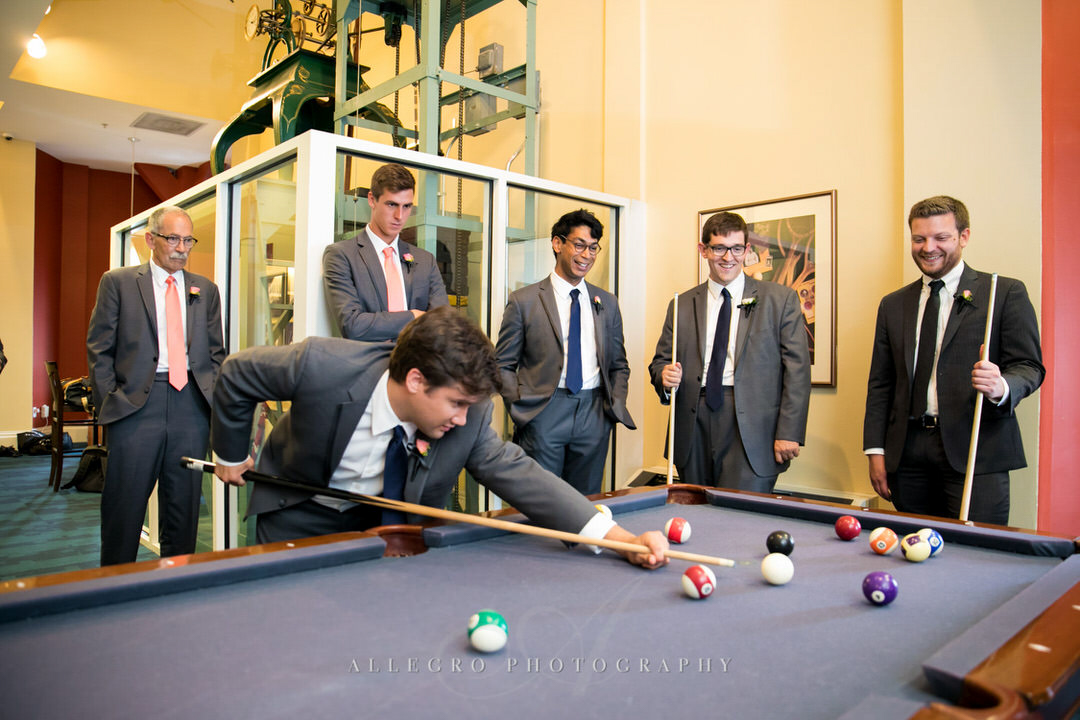 groom and groomsmen playing pool