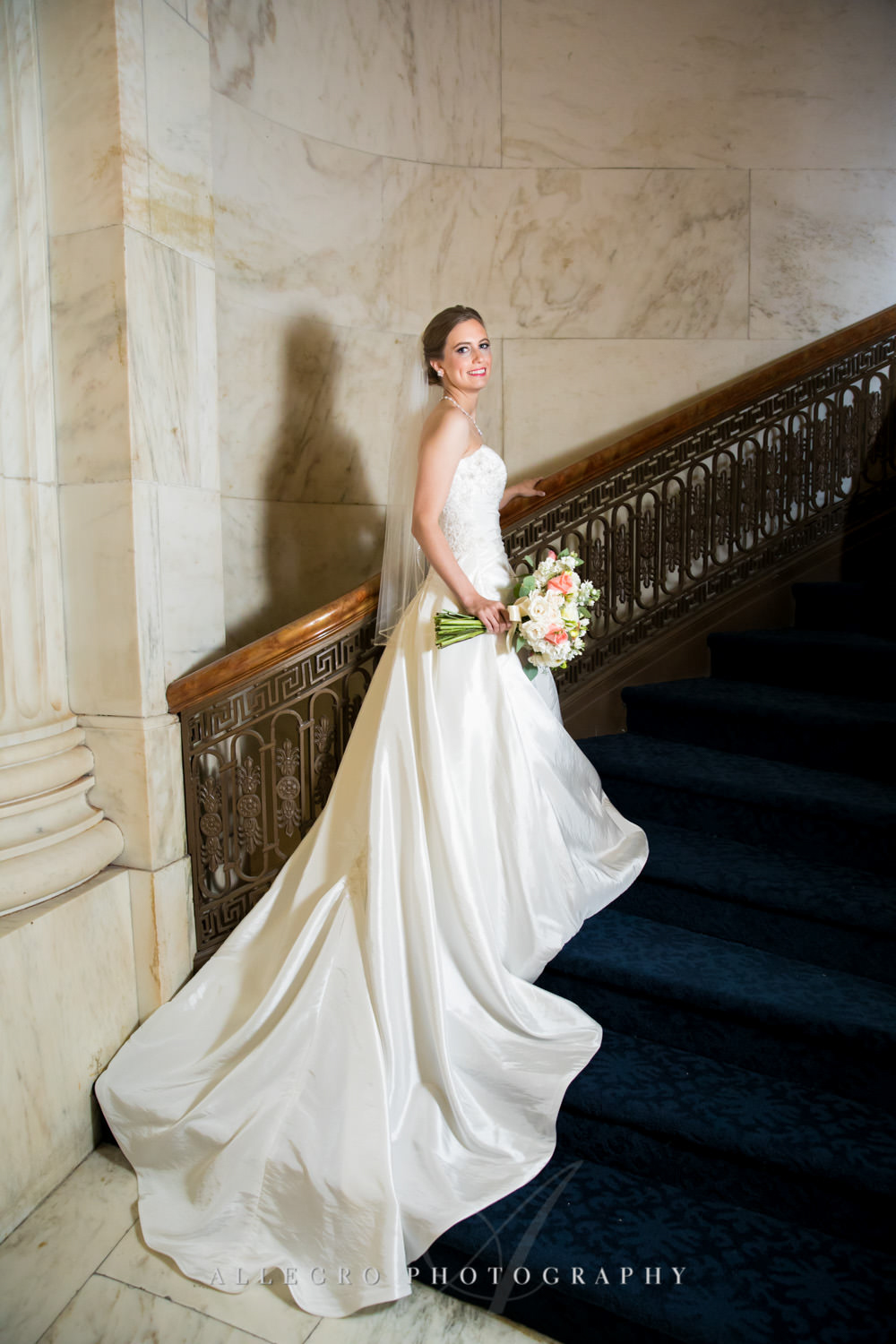 bride poses on stairs in custom house