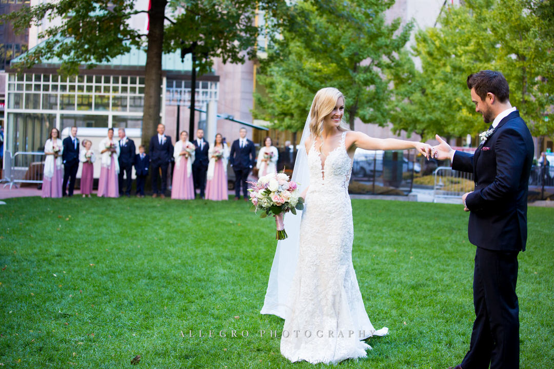 bride and groom dance in post office square while bridesmaids and groomsmen watch