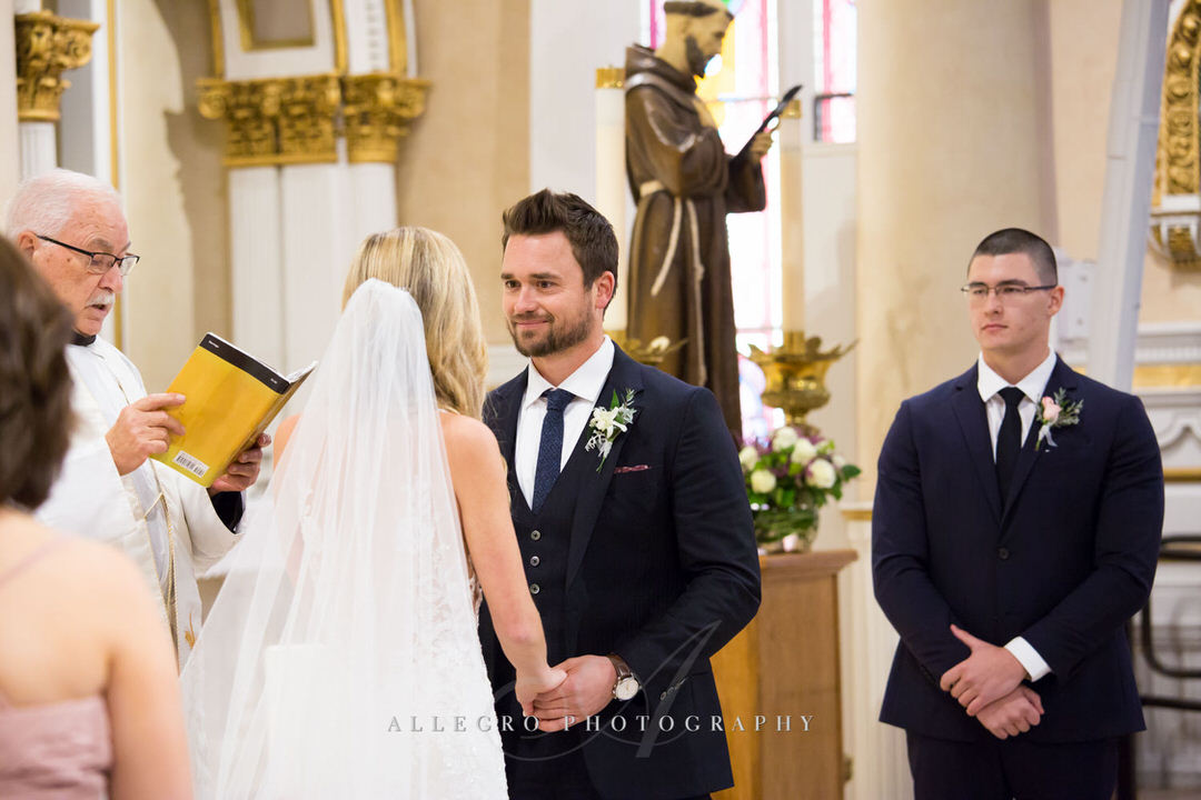 groom looks into brides eyes while at the altar