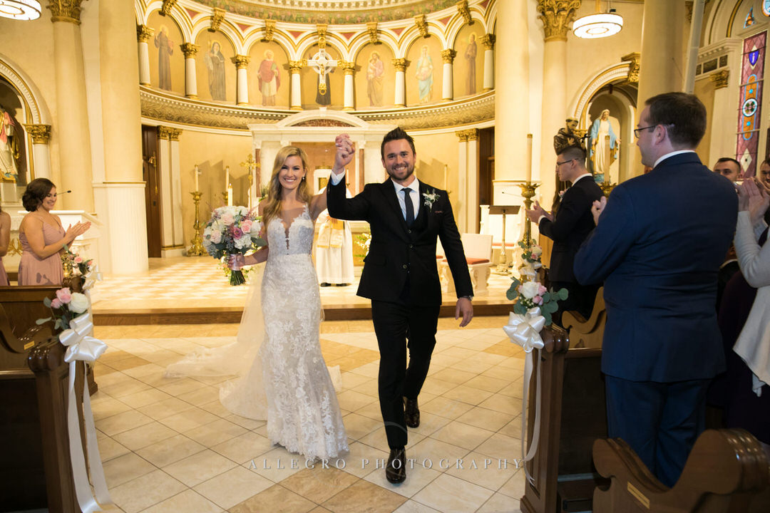 bride and groom walking out of church as husband and wife