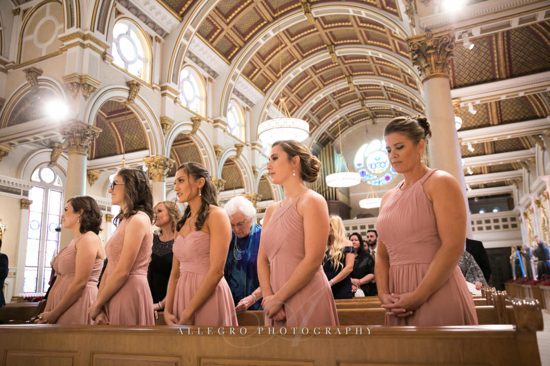bridesmaids watch from a pew