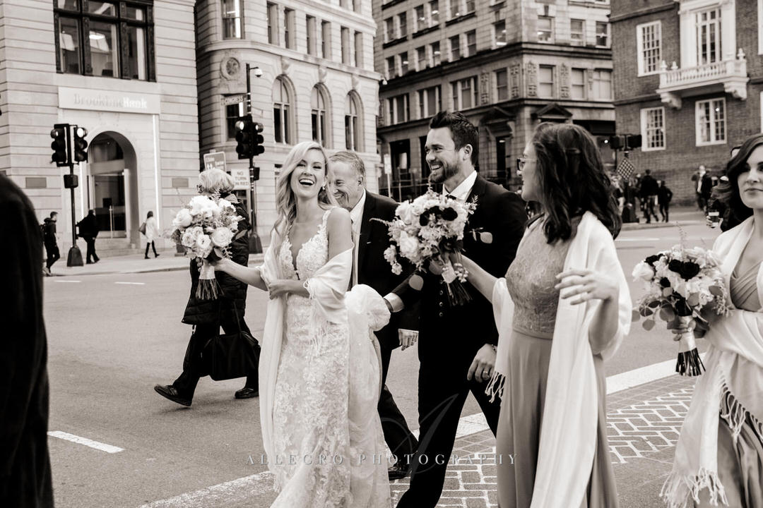 bride and groom walking through boston